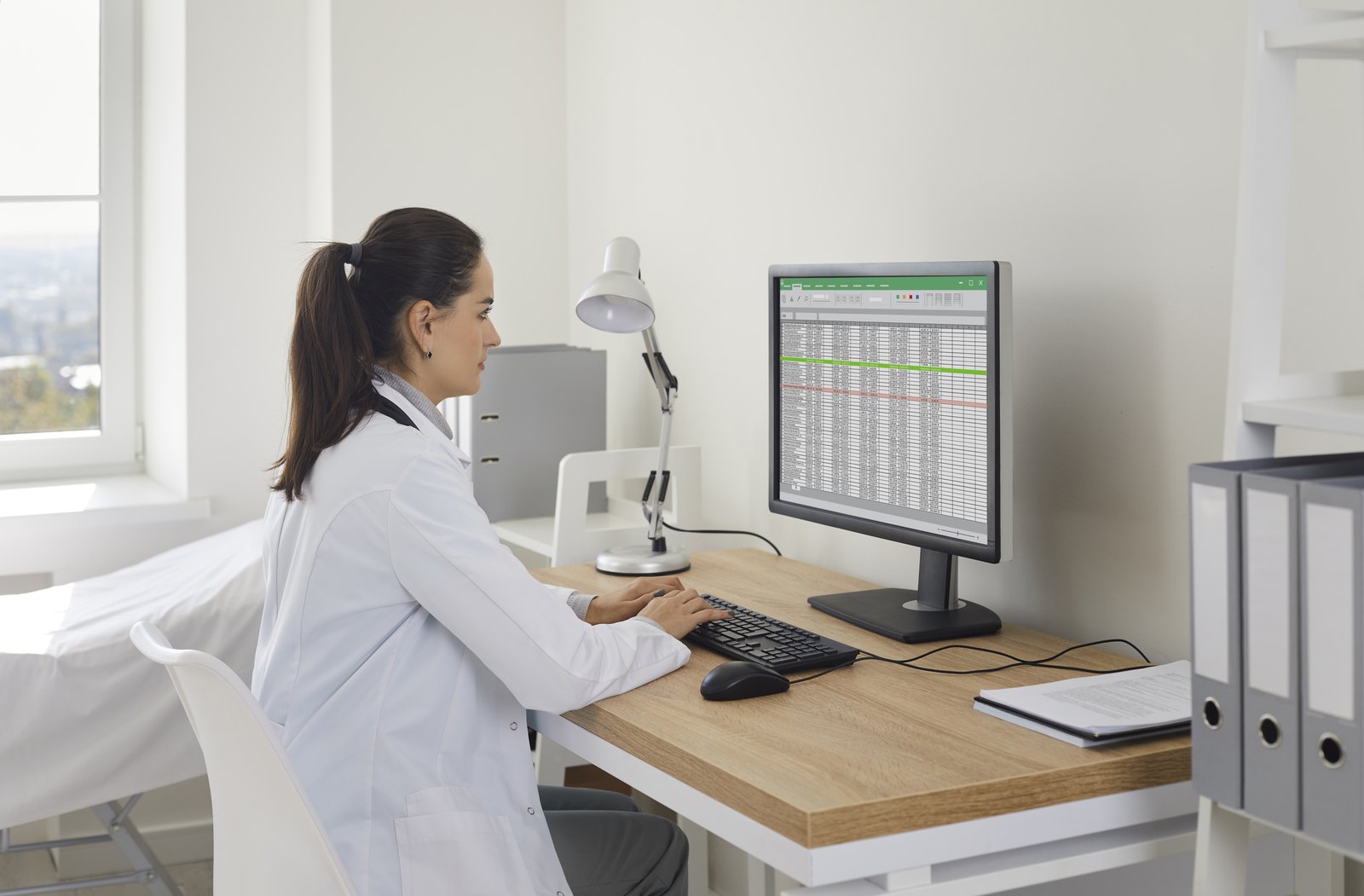 tilt-billing-challenge-cbx70335324 Provider reviewing a billing spreadsheet at a desk