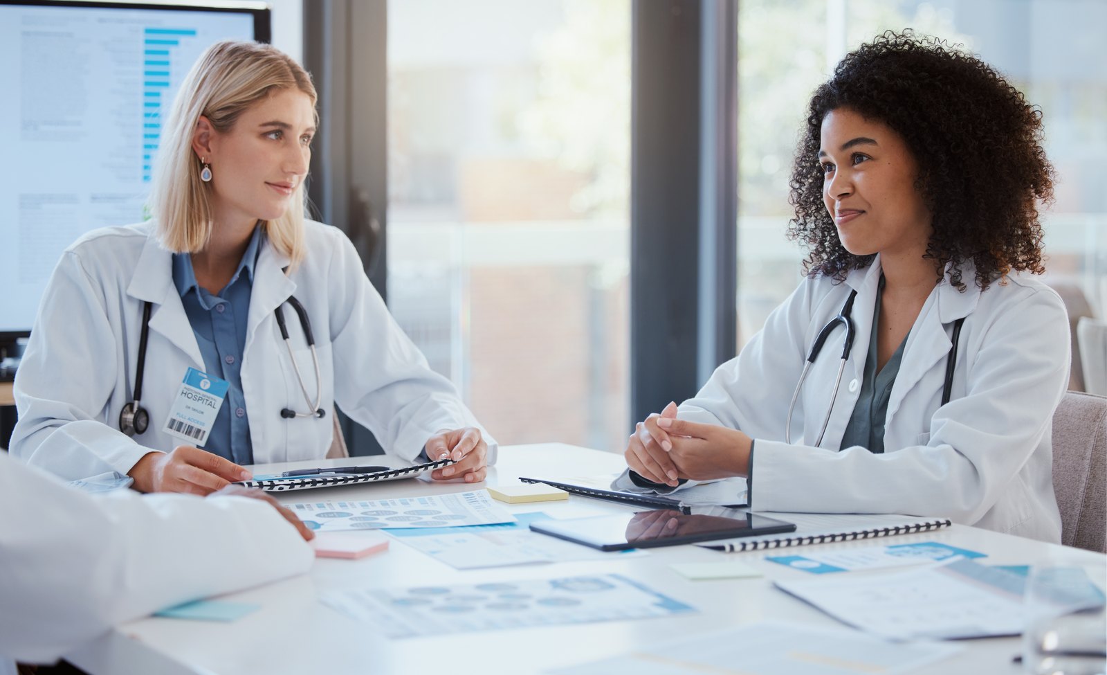 tilt-billing-hero-cbx61389072 Two practice leaders reviewing reports together at a table